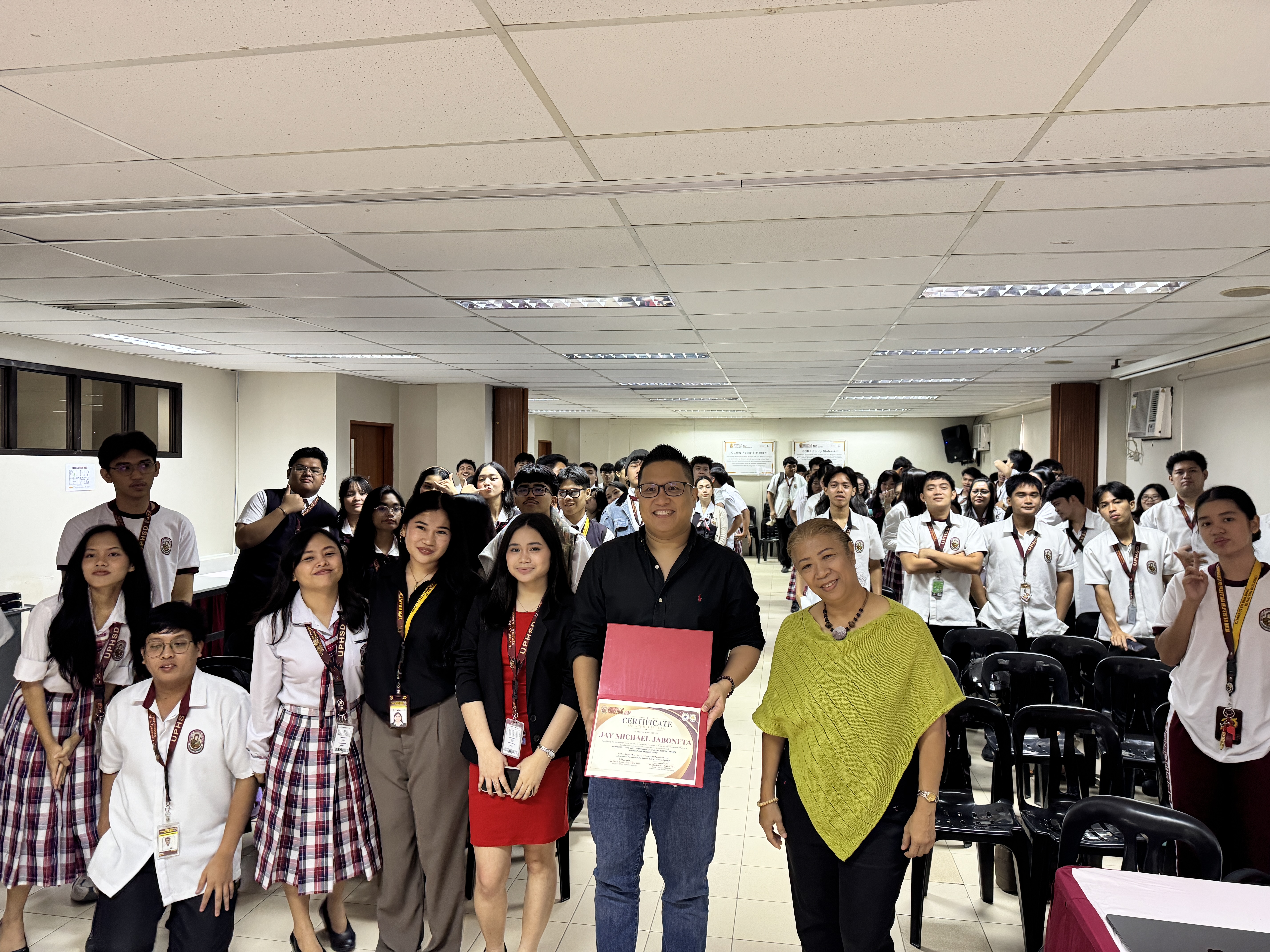 Jay Jaboneta and UPHSD Molino students with the Entrepreneurship Program Chair after the AI video production workshop